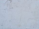a plaque on the side of a building with writing on it
