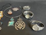 many different pieces of jewelry sitting on a table