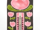 a thermometer with a pink flower design on it