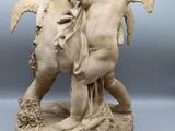an image of a statue of two angels on a horse
