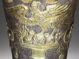 a vase with a bird on it sitting on a table