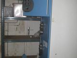 an image of a blue metal shelf with a sign on it