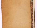 a close up of an old book with a piece of paper on top of it