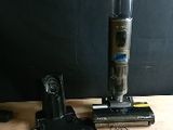 a vacuum that is sitting on a table next to other items