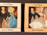 two dolls in a box one is a bride and the other is a groom