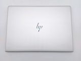 the back of a white laptop computer sitting on top of a white table
