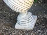 a vase that is sitting on top of a stone base