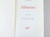 an open book with red writing on it sitting on top of a table