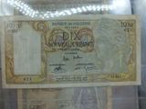 une photo d'un billet de banque sur lequel figure le portrait d'une femme