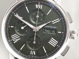 a close up of a watch with roman numerals on the face