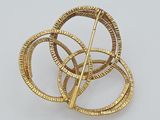 an image of a gold plated brooch or pin with a spiral design