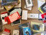 a cardboard box filled with electronics and a teddy bear