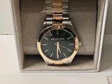 michael korsch watch in a box on a white surface