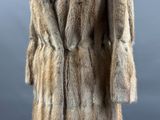 an image of a fur coat on a mannequin stand