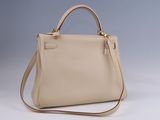 a white handbag with a brown strap on a gray background