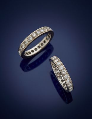 a pair of diamond eternity rings, by cartier