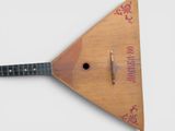 a small wooden instrument with a wooden stick on it