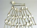 a lot of silver spoons and spoon spoons on the table