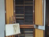 a wooden cabinet with a drawing on it in a room