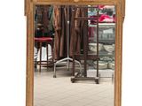 a mirror that is sitting on the floor in front of a chair