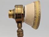 a gold colored lamp with a paper cone on it