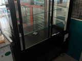 a glass display case in the middle of a room