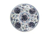 a blue and white plate with a floral design on it
