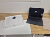 a laptop computer sitting on top of a table next to a laptop computer