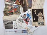 a pile of old postcards on a white table