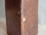 a brown book sitting on top of a white table