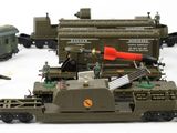 a lot of toy army vehicles and trains on a white surface