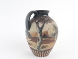 a vase with a painting on it sitting on a table