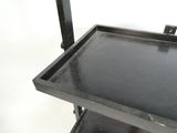a black shelf with a black tray on it