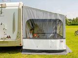an image of a camper trailer parked in a grassy field