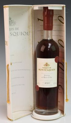 an old bottle of wine sitting inside of a box on top of a table