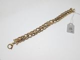 a close up of a gold bracelet with a tag on it