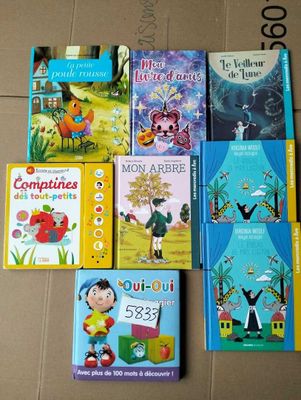 several children ' s books are lined up on the floor