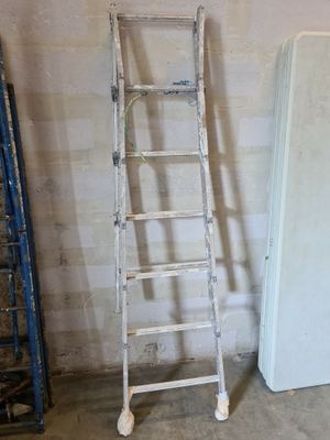 a ladder leaning against a wall next to a refrigerator