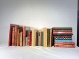 a lot of books that are sitting on a bed