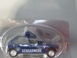 a blue toy car in a plastic package on a table