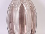 a glass vase that is sitting on a white surface