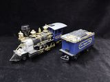 two toy trains that are sitting on a black surface