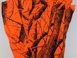 a close up of a shirt with orange and black trees on it
