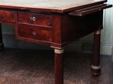 a wooden table with two drawers on it in a room