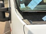 a car with a lot of stickers on it ' s windshield