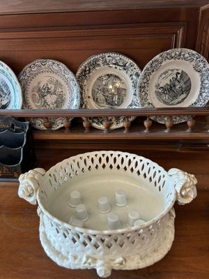 a lot of plates and bowls on a shelf