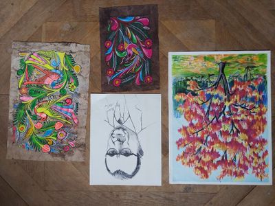 quatre tableaux de couleurs différentes posés les uns à côté des autres sur un parquet