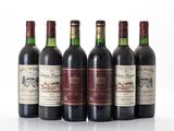 six bouteilles de vin sont alignées sur une surface blanche