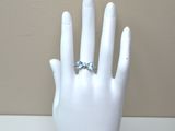 a white mannequin hand with a diamond ring on it