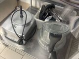 two pots and pans sitting on a metal shelf